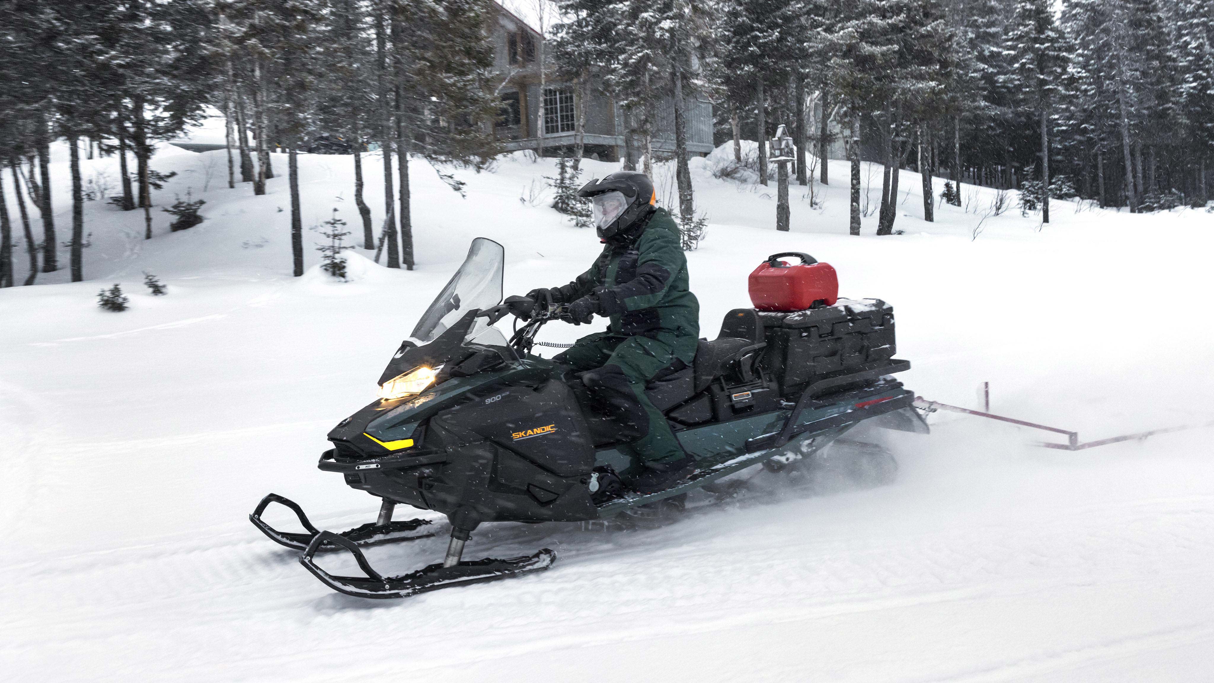 Rider towing with his Ski-Doo Skandic equipped with LinQ accessories